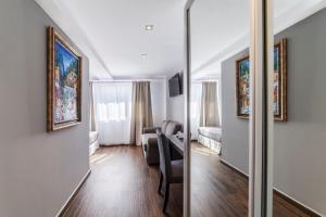 a living room with a couch and a bedroom at Essence Hotel Boutique in Torremolinos