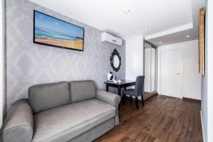 a living room with a couch and a table at Essence Hotel Boutique in Torremolinos
