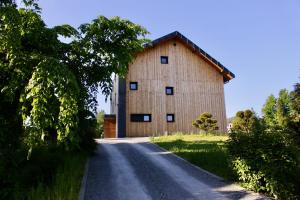 a large barn on the side of a road at Garden Loft in Roczyny