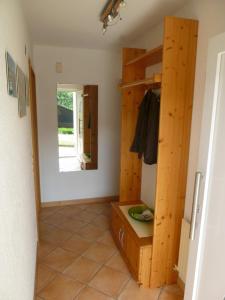 a room with a hallway with wooden walls and a mirror at Haus Böhler in Fröhnd