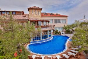 an image of a house with a swimming pool at Palace Hotel Olive Odore in Küçükkuyu