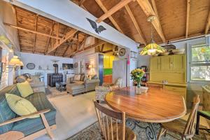 a kitchen and living room with a wooden table and chairs at Quiet and Lovely Lakefront Cottage for Families! in Union +20 photos
