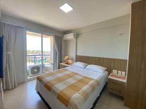 a bedroom with a large bed and a balcony at AllMar Flats - Apartamentos frente mar - Beach Village in Fortaleza +47 photos