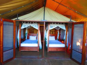 2 Betten in einem Zimmer mit Zelt in der Unterkunft Naara Eco Lodge & Spa in Chidenguele