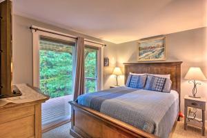 a bedroom with a bed and a large window at Cozy Home with Sauna Mins to Stowe Mountain Resort in Stowe