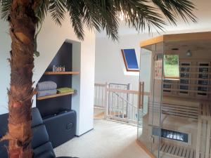 a room with a palm tree next to a staircase at Ferienwohnung-Lerchensteige in Haundorf