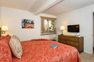 a bedroom with a bed with a book on it at Standard Two Bedroom - Aspen Alps 101 in Aspen