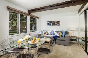 a living room with a table and a couch at Standard Two Bedroom - Aspen Alps 101 in Aspen