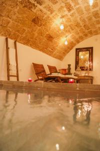 a house with a swimming pool and a dining room at CORTE LARGO LAURO DIMORE & SPA in Gemini