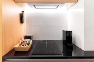 A kitchen or kitchenette at LOFT DESIGN GRANADA CENTER 2min CATHEDRAL FREE WIFI