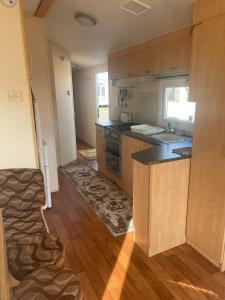 a kitchen with a sink and a counter top at 8 Berth on The Grange (Summer) in Ingoldmells
