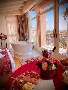 a bathroom with a bath tub and a plate of food at Relais Colle San Pietro in Verona