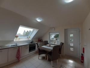 a kitchen with a table and chairs and a window at -Christas Nest- Ferienwohnung in Lüneburg in Lüneburg +12 photos