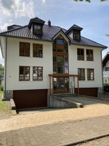 a large white house with a lot of windows at Strand24 in Ostseebad Nienhagen