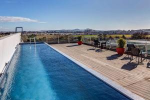 a swimming pool on the roof of a building at Wyndham Concepcion Pettra in Concepción