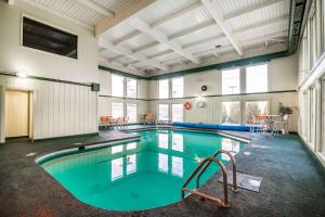 a large swimming pool with blue water in a building at Quality Inn Rutland in Rutland