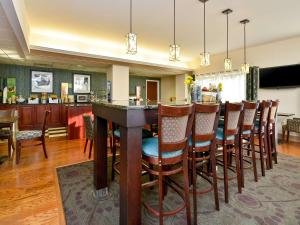 a dining room and kitchen with a bar and chairs at Comfort Inn Saco - Old Orchard Beach in Saco