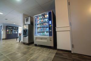a large refrigerator in a store with drinks in it at SureStay Studio by Best Western Hardisty in Hardisty