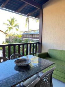 a table and chairs on a balcony with a table at Nannai Residence -Muro Alto/PE in Porto De Galinhas