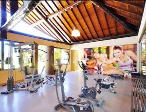 a gym with two women in a room with exercise bikes at Nannai Residence -Muro Alto/PE in Porto De Galinhas