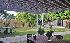 a patio with tables and chairs under a pergola at Agriturismo Basegò in Venice