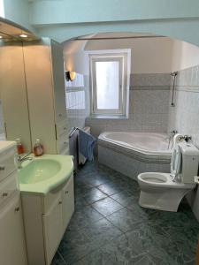 a bathroom with a tub and a toilet and a sink at Schlaffburg in Klosterneuburg