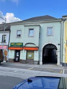 a building on a street with a car parked in front at Schlaffburg in Klosterneuburg