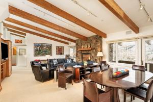 a living room with a couch and a table and chairs at Deluxe 3 Bedroom - Aspen Alps #508 in Aspen