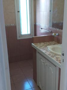 a bathroom with a sink and a mirror at Descanso,verde,paz in Mar del Plata