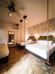 a bedroom with two swinging beds and a mirror at 40 Cañones in Mahahual