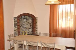 a dining room with a wooden table and chairs at Apartment in Lazise - Gardasee 41952 in Lazise