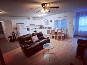 a living room with a leather couch and a table at Bear Creek Suite in Surrey