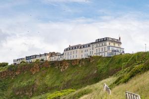 a large building on top of a hill at The Norbreck Hotel in Scarborough