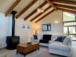 a living room with a couch and a wood stove at Best On Bills in Wanaka