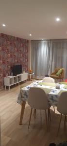 a living room with a table and chairs and a television at Modern and cozy apartment in Centro International in Bogotá