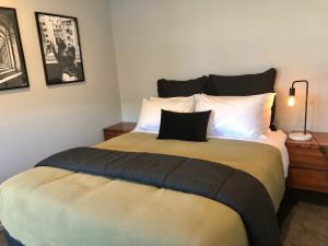 a bedroom with a large bed with a pillow on it at Central, Cosy, Convenient in Twizel