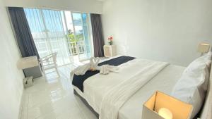 Voodi või voodid majutusasutuse Pom Pom's Bali Apartments toas