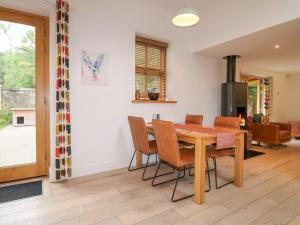 a kitchen and dining room with a wooden table and chairs at Grey Roofs in Stanton