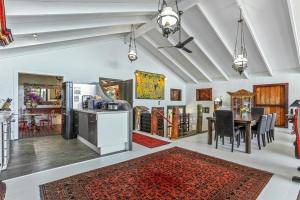 a living room with a kitchen and a dining room at Balinese Beach House, Sunshine Beach in Sunshine Beach