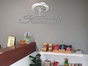 a counter top with a sign for a restaurant at Jacaranda Country Motel in Saint George