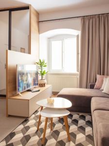 a living room with a couch and a tv at Baštova apartment in Bratislava