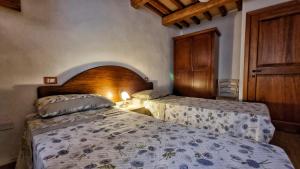 Posteľ alebo postele v izbe v ubytovaní La casa della maestra località San Giovanni Spello