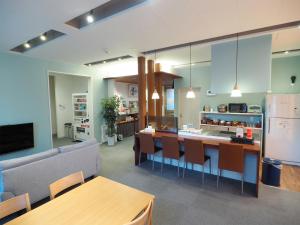 a kitchen and living room with a couch and a table at Choine Hotel Sapporo Teine in Sapporo