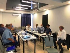 um grupo de homens sentados à mesa numa sala em Vita Gardenia Hotel Tskaltubo em Tskaltubo mais 37 fotografias