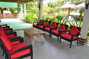 a group of chairs and a table on a patio at TME Retreats Dhigurah in Dhigurah