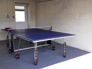 a ping pong table in a room at Paddock House in Ashbourne