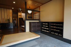 a room with a wine cellar with a wooden cabinet at Soumeian in Kusatsu