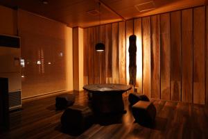 a room with a table and some stools in it at Soumeian in Kusatsu +18 photos