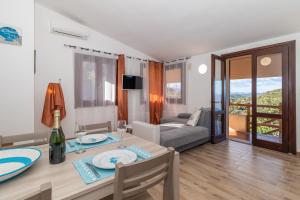 - un salon avec une table à manger et un lit dans l'établissement Villa Aloe 2, à Costa Paradiso