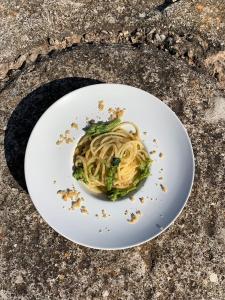 a plate of pasta and broccoli on a table at Masseria Borgo Santuri in Ostuni